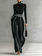 Two-piece women’s set with high-neck long-sleeve top, wide-leg trousers, and belt