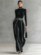 Two-piece women’s set with high-neck long-sleeve top, wide-leg trousers, and belt